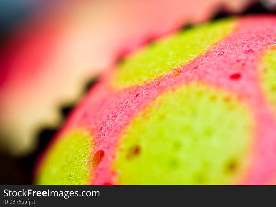 Extreme close up view of the delicious colorful cup cakes showing craters. Extreme close up view of the delicious colorful cup cakes showing craters