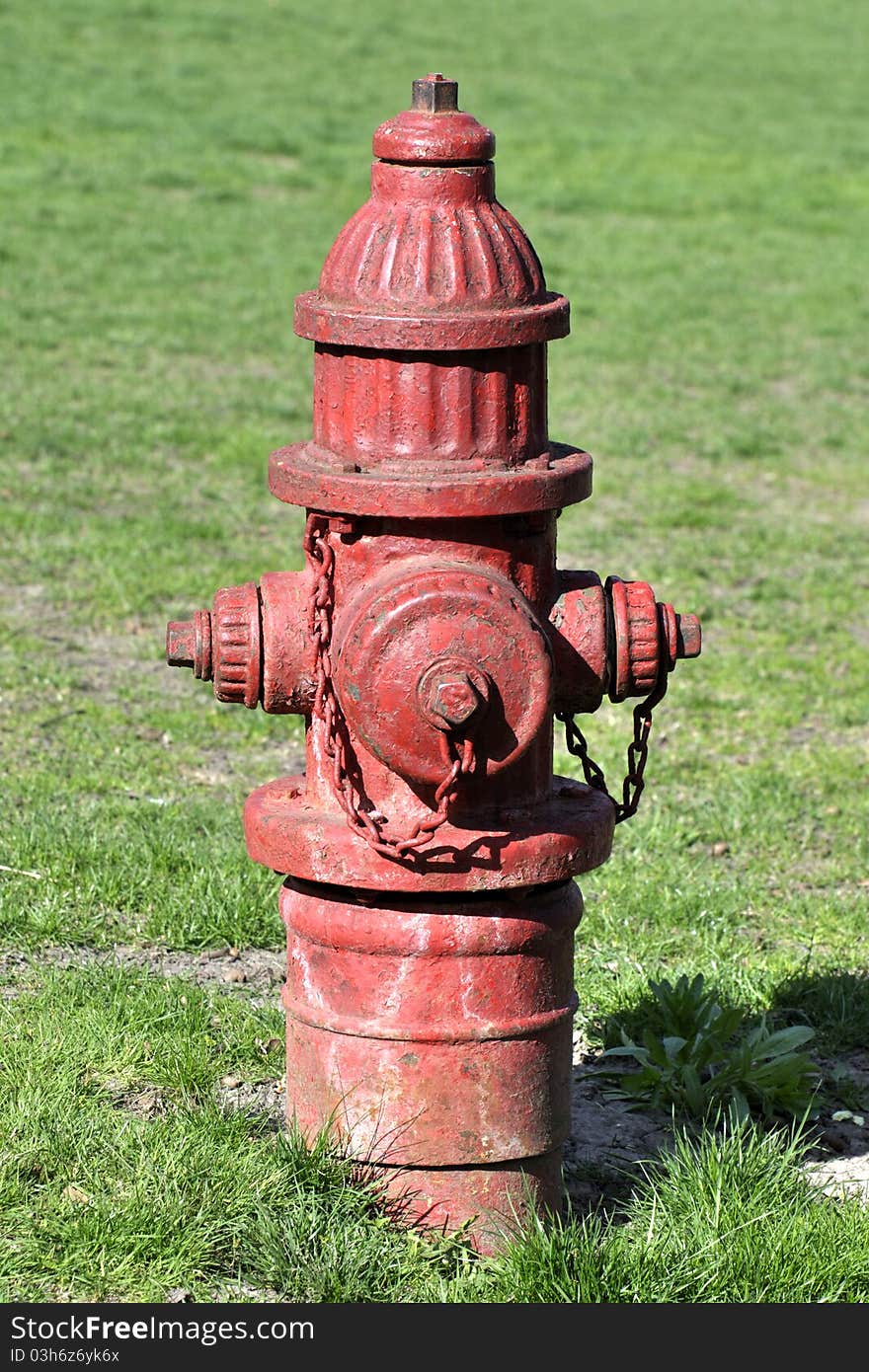 Classic red fire hydrant in green lawn