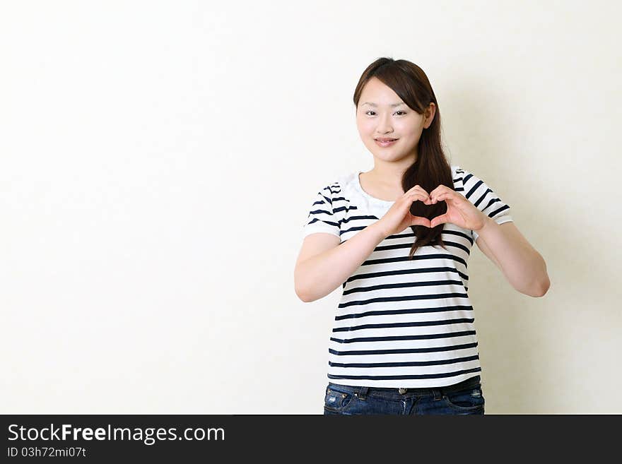 Happy Woman Make Heart Shape By Her Hands