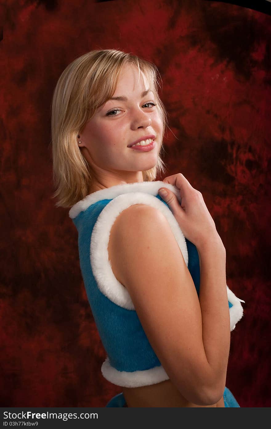 Photo of a young girl in costume of snow maiden, playfully smiling and posing to the camera. Photo of a young girl in costume of snow maiden, playfully smiling and posing to the camera