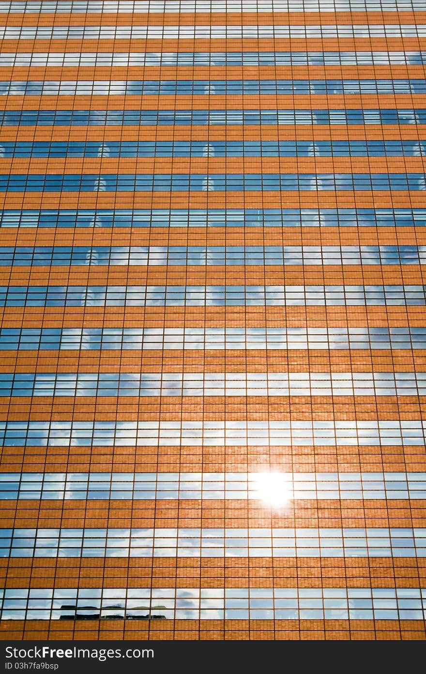 Facade of a modern skyscraper reflecting sun