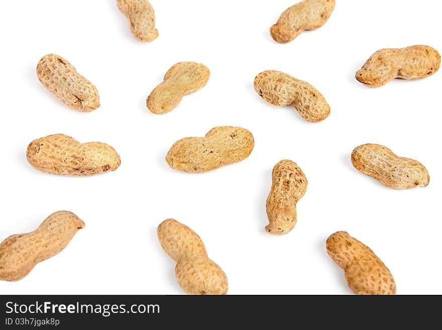 Groundnuts in peels background on white