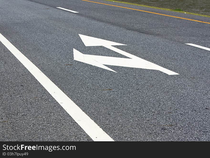 Arrows showing the left and straight on the road. Arrows showing the left and straight on the road.