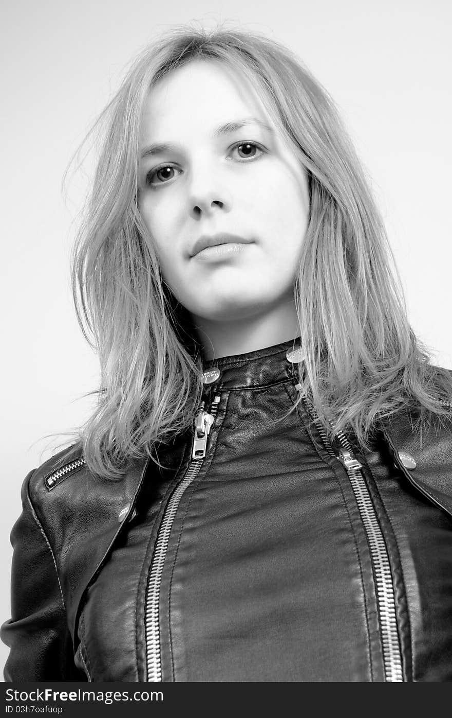 Portrait of an attractive beautiful blond woman in a black leather jacket. Portrait of an attractive beautiful blond woman in a black leather jacket