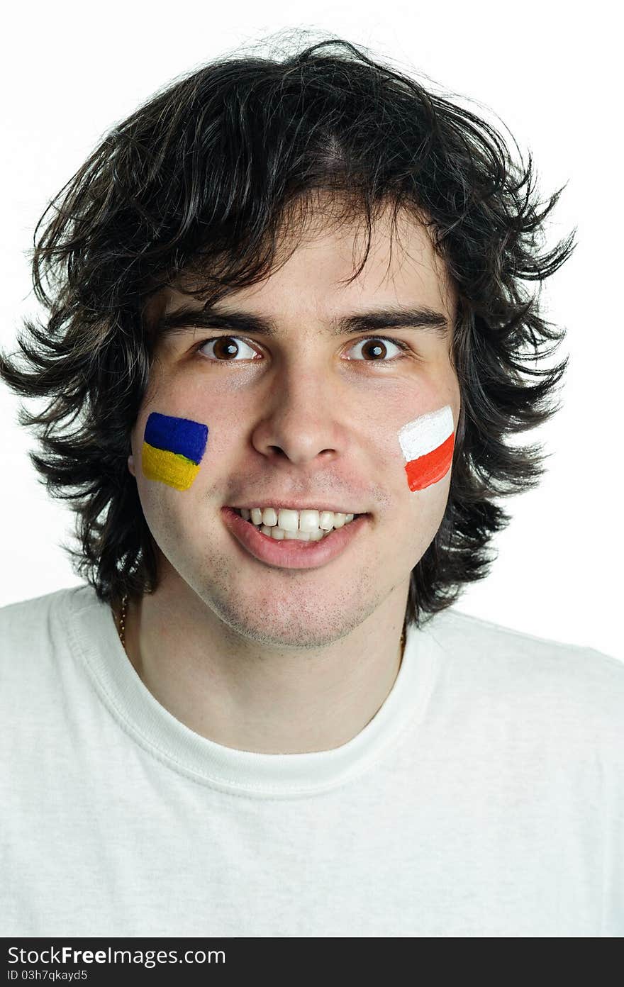 An image of football fan with flags on face. An image of football fan with flags on face