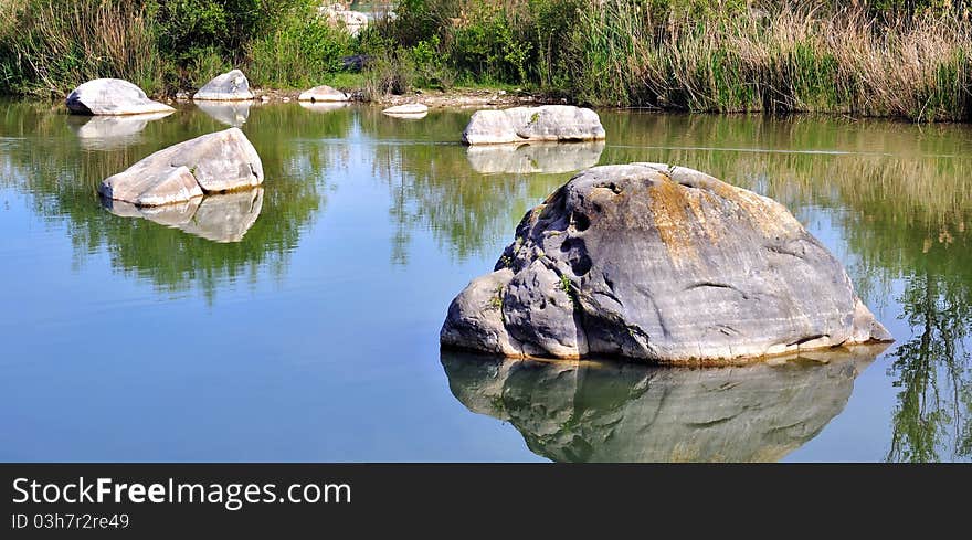 Rocks Scattered In The Lake Water