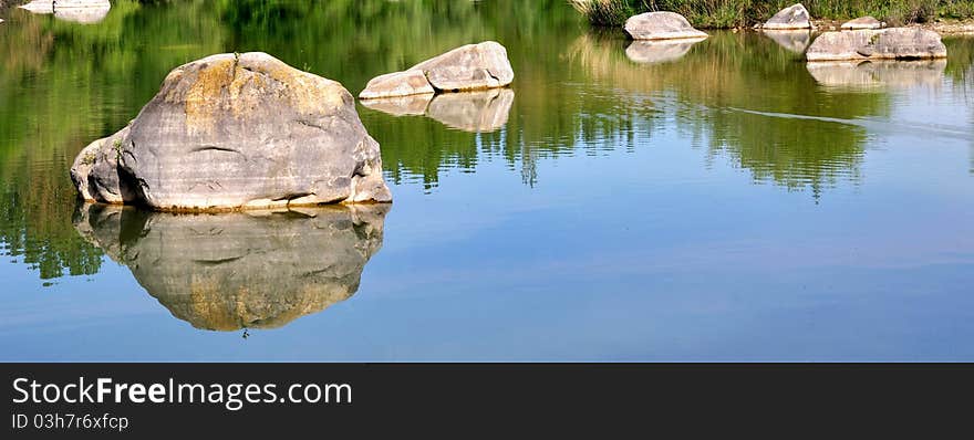 Rocks Scattered In The Lake Water