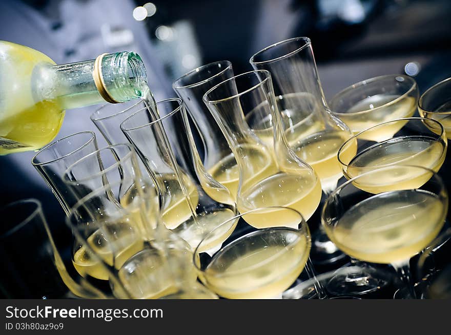 Pouring colorful Limonchello in glasses. Pouring colorful Limonchello in glasses