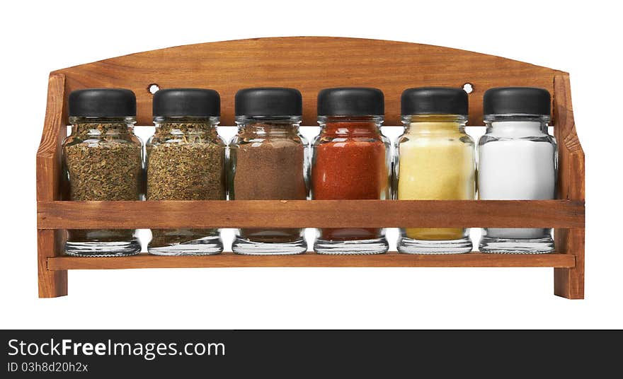 Set of spices in glass bottles, isolated on white background