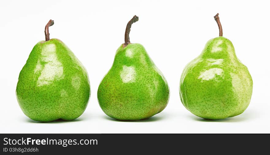 Three green pears on white background