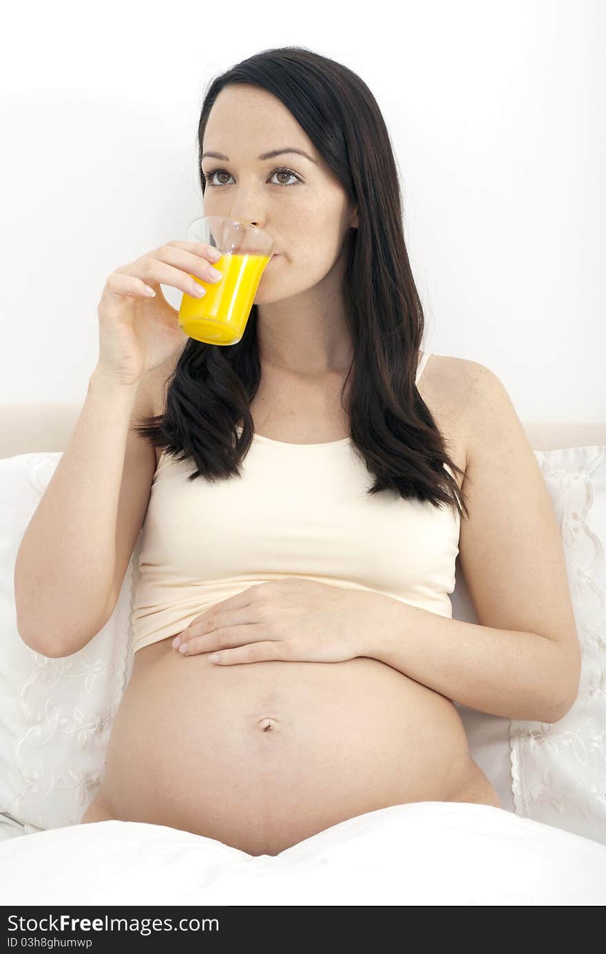 Pregnant woman drinking orange juice