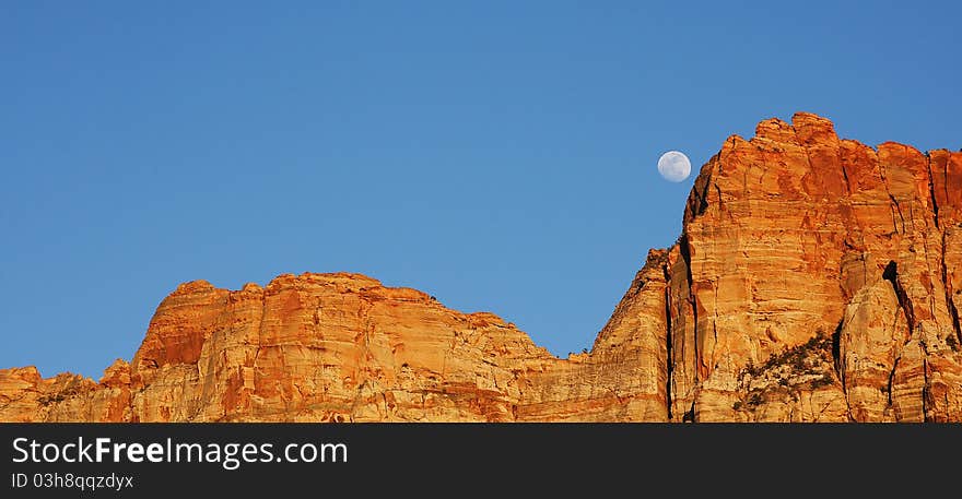 Moon coming up over the Red Sandstone rock in Zion National Park located in Southern Utah. Moon coming up over the Red Sandstone rock in Zion National Park located in Southern Utah.