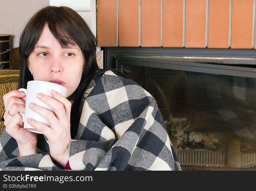 A woman drinking from white cup