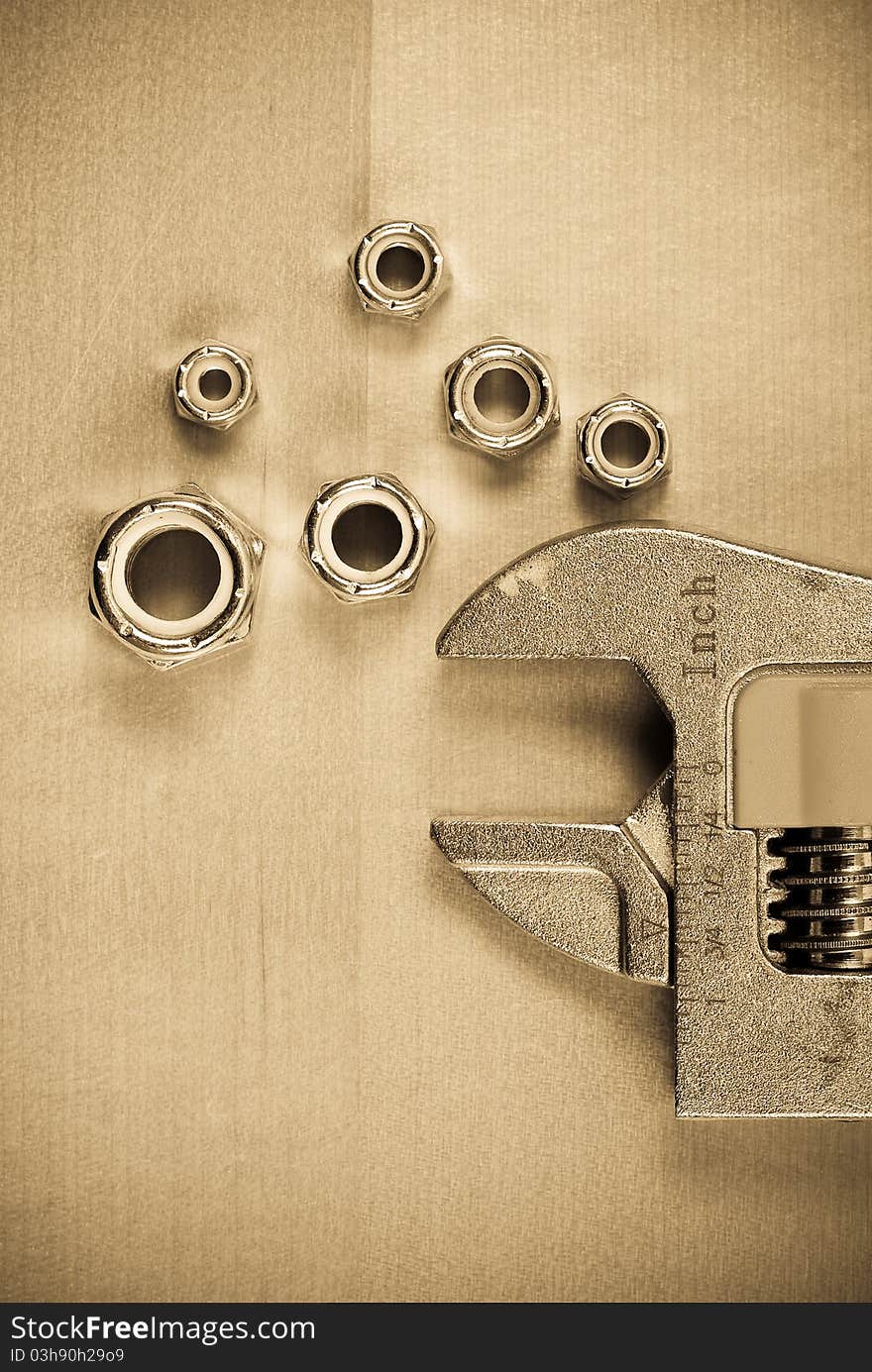 Various Bolt Heads and Wrench in Sepia