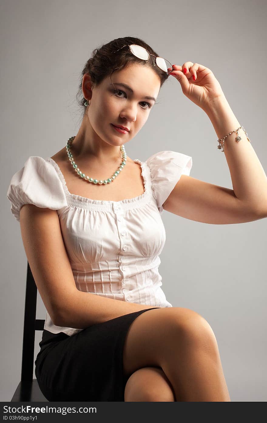 Young business woman with glasses call cell phone on chair. Young business woman with glasses call cell phone on chair