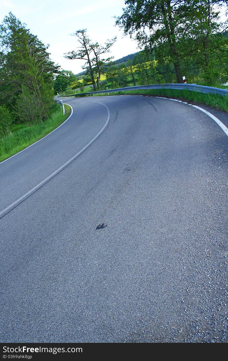 Road curve at a pond.