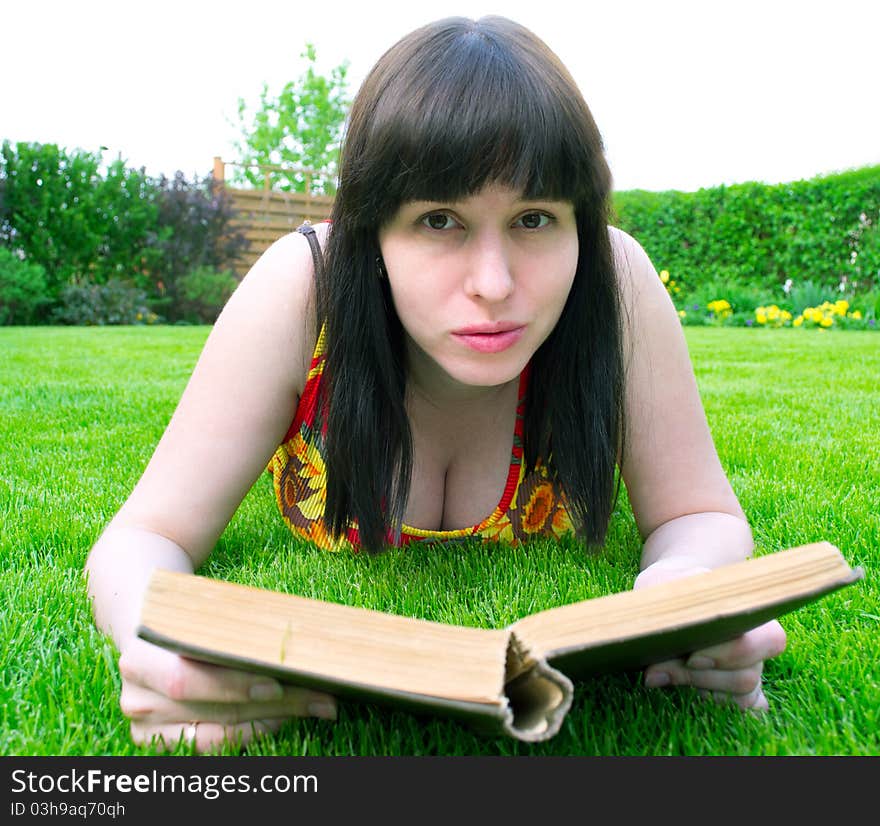 Woman on grass reading a book