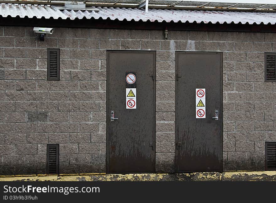 Two doors with prohibitory signsÐ± rainy weather