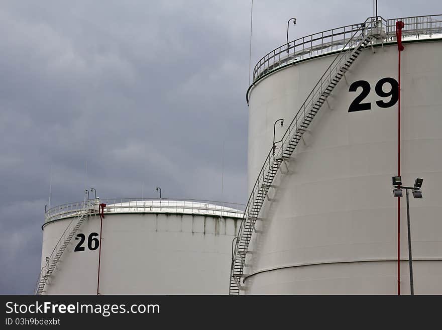 Tanks in oil refinery factory on the cloudy sky. Tanks in oil refinery factory on the cloudy sky