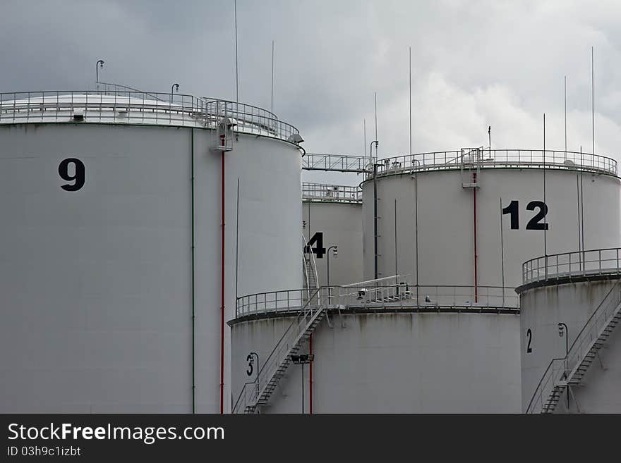 Tanks in oil refinery factory on the cloudy sky. Tanks in oil refinery factory on the cloudy sky