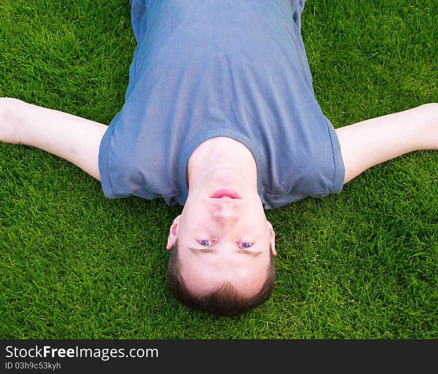 Young man lying on green grass. Young man lying on green grass