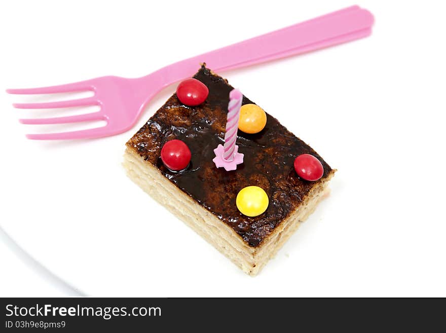 Isolated cake with a pink fork. Isolated cake with a pink fork