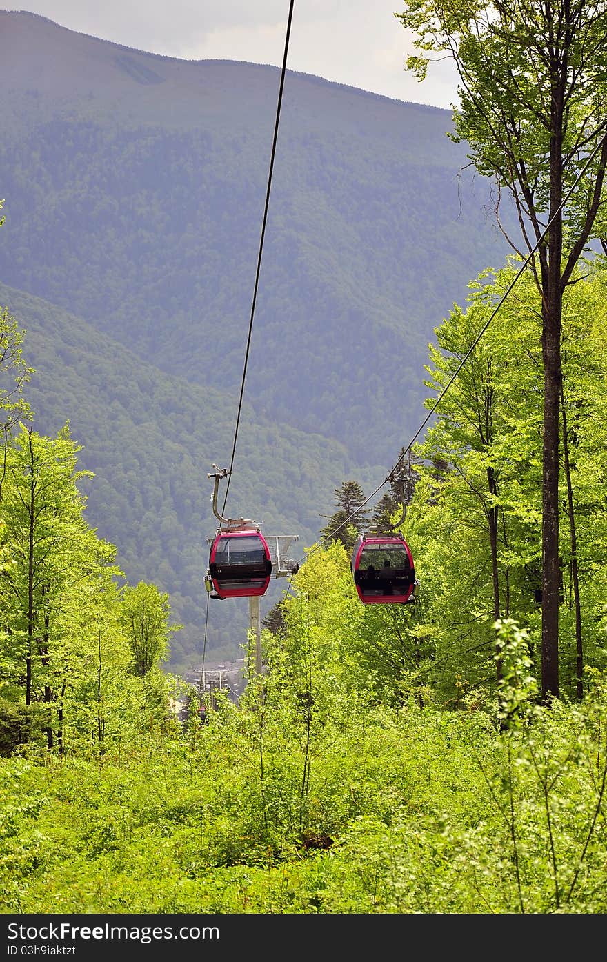 Twin cable car traveling through the forest. Twin cable car traveling through the forest