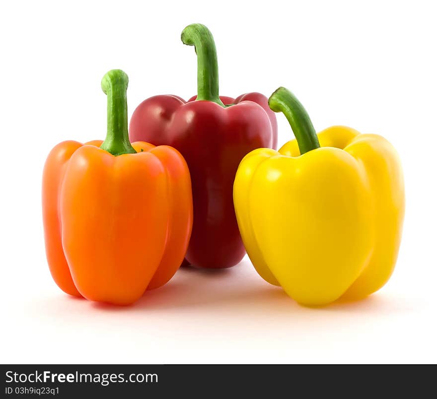 Three color peppers isolated on white background