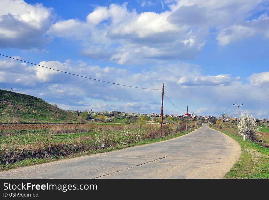 Curved road under cloudy sky