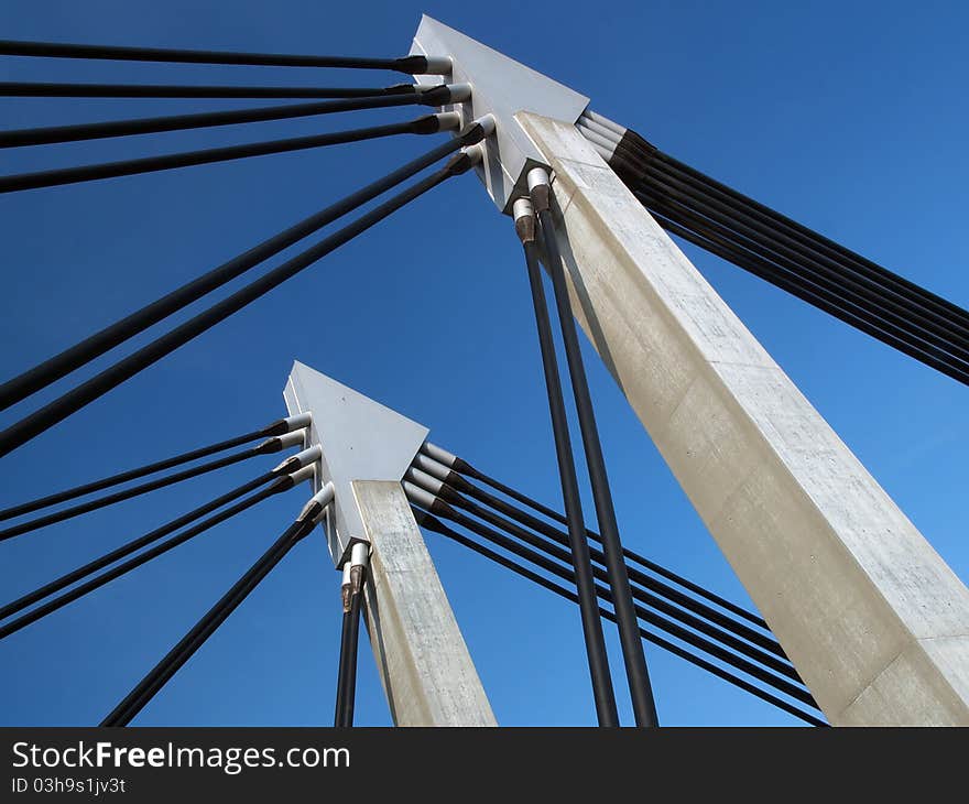 Closeup of bridge construction over blue sky