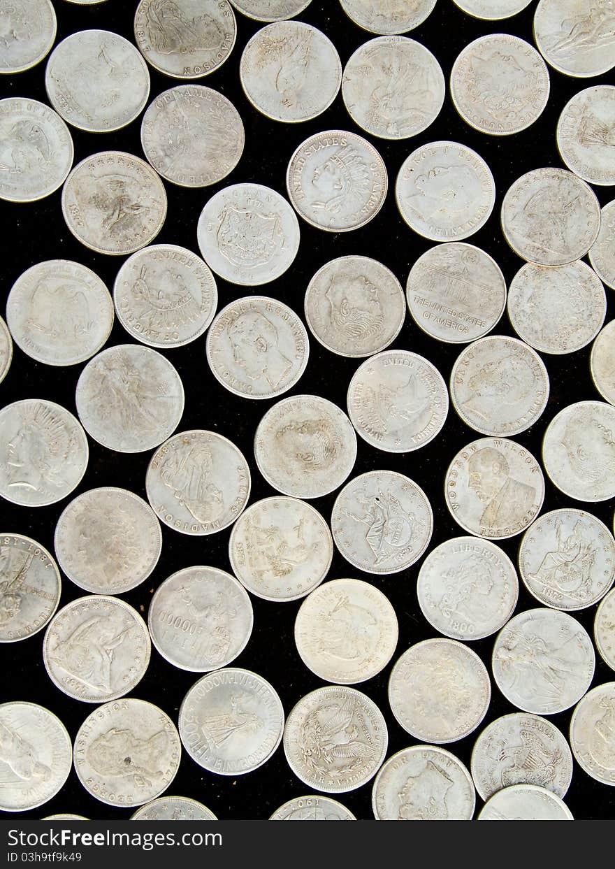 Different old coins on a black background