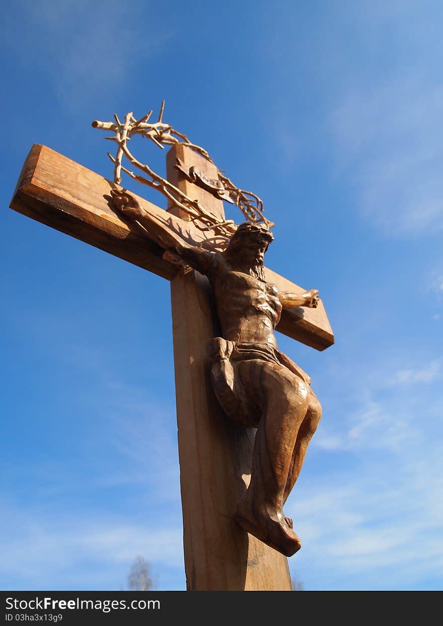 A wooden Crucifix with a blue sky