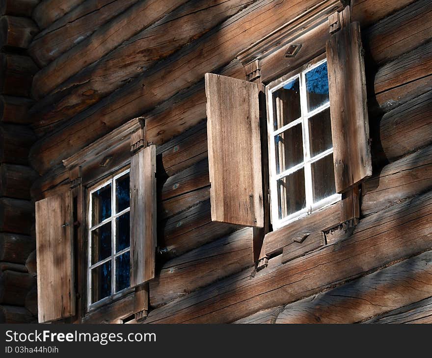 Wooden log house with windows. Wooden log house with windows