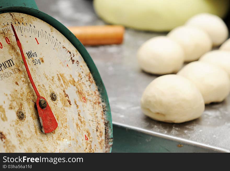 Close up old bakering weight scale machine isolated dough and bakering roller in blur at background