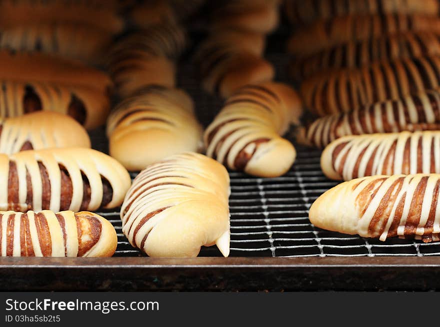 Fresh bread cake on cooler rack, focus on infront and blur to the back.