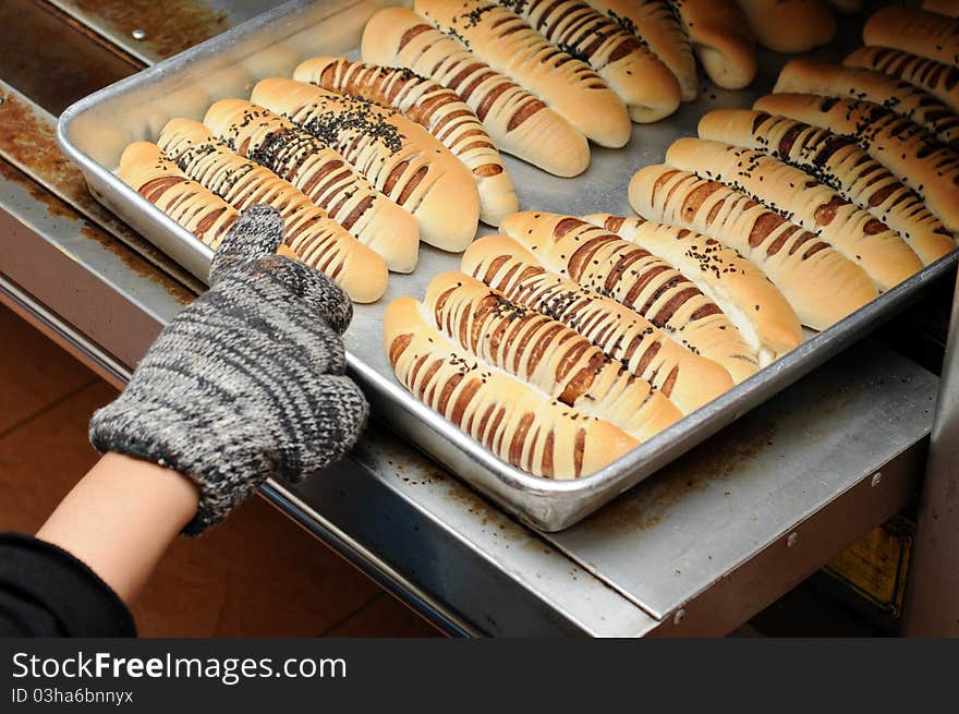 Hand pull out baked bread on tray