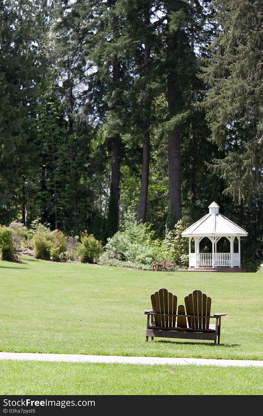 A White Gazebo Set On A Lake