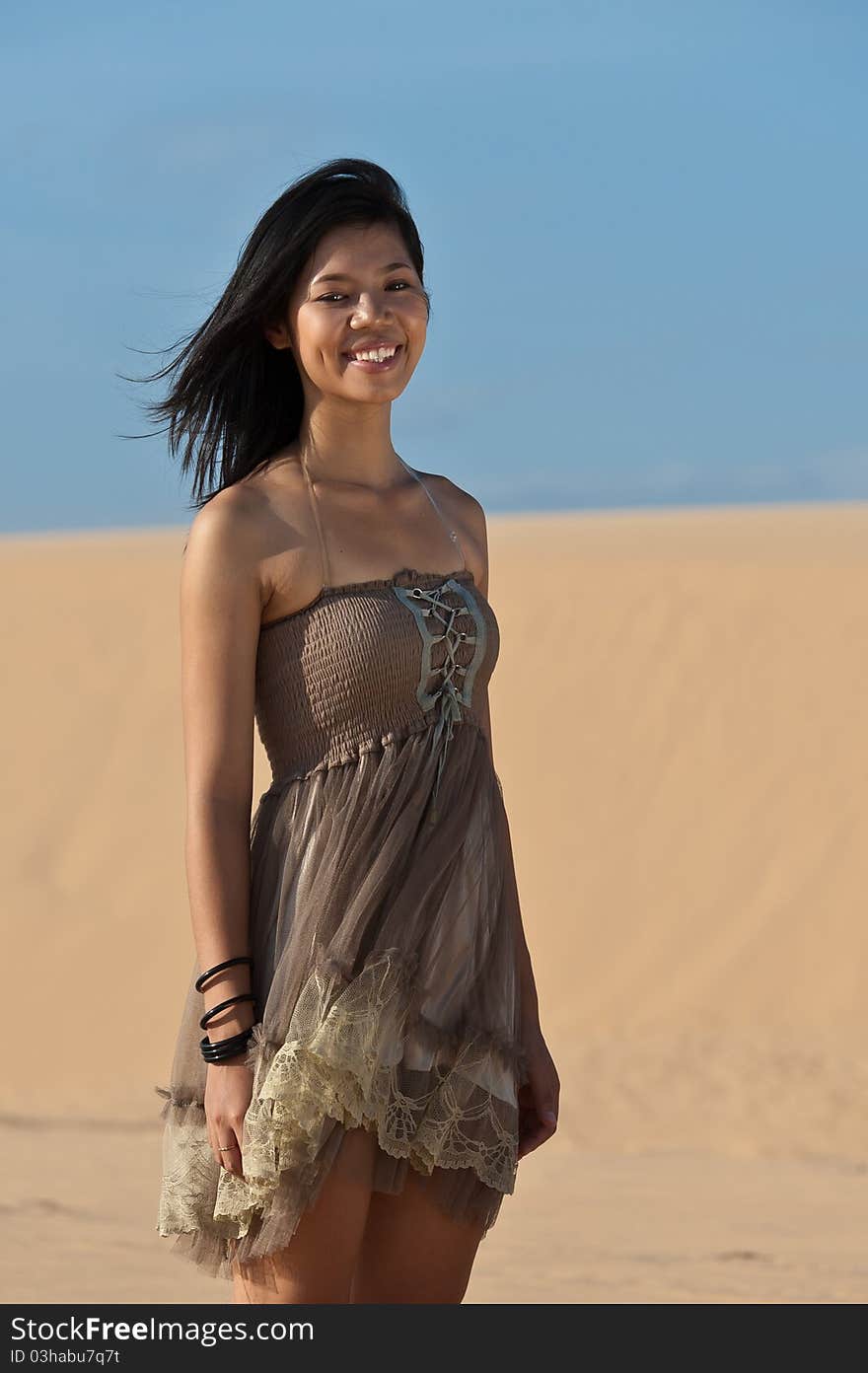 Joyous young woman in dunes