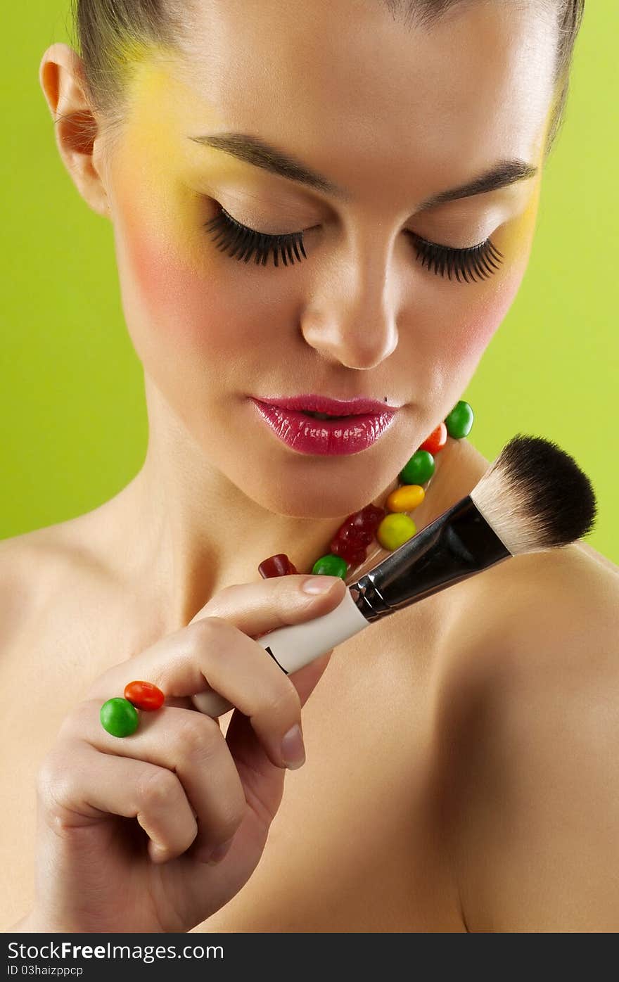 Close-up portrait of beautiful brunette with glamor make-up and color candy style