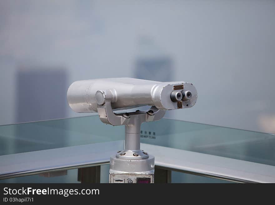 Telescope at a lookout point in front of blue sky