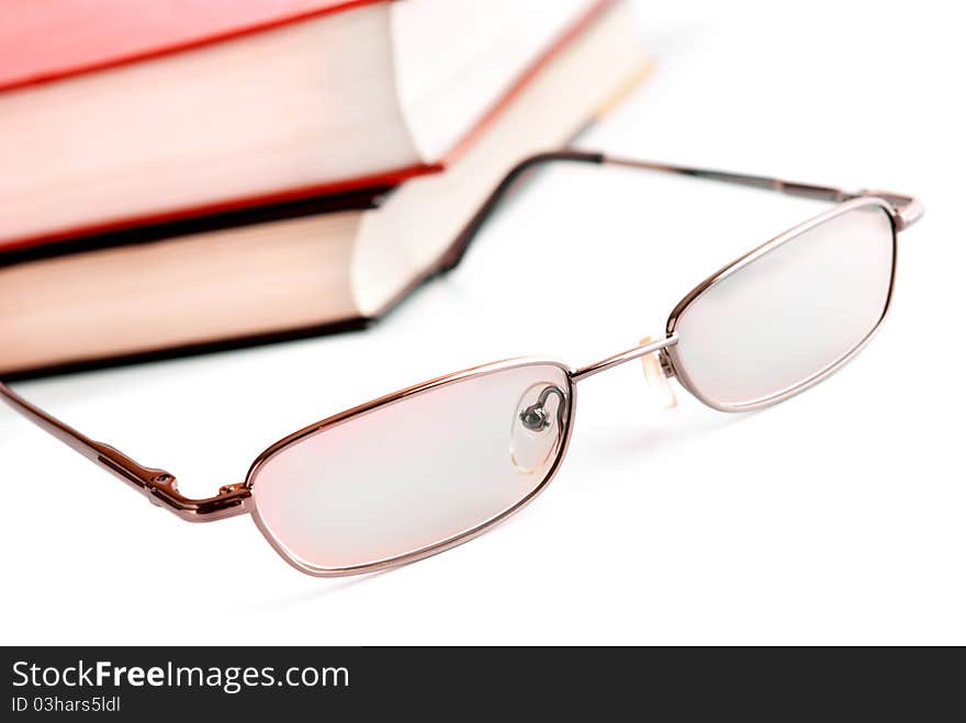 Glasses close up and the books on a background. Glasses close up and the books on a background