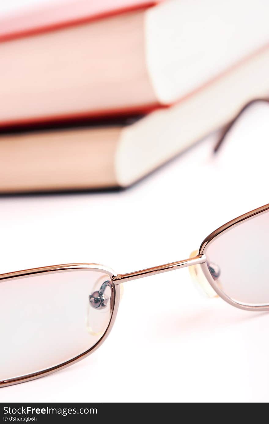 Glasses close up and the books on a background. Glasses close up and the books on a background