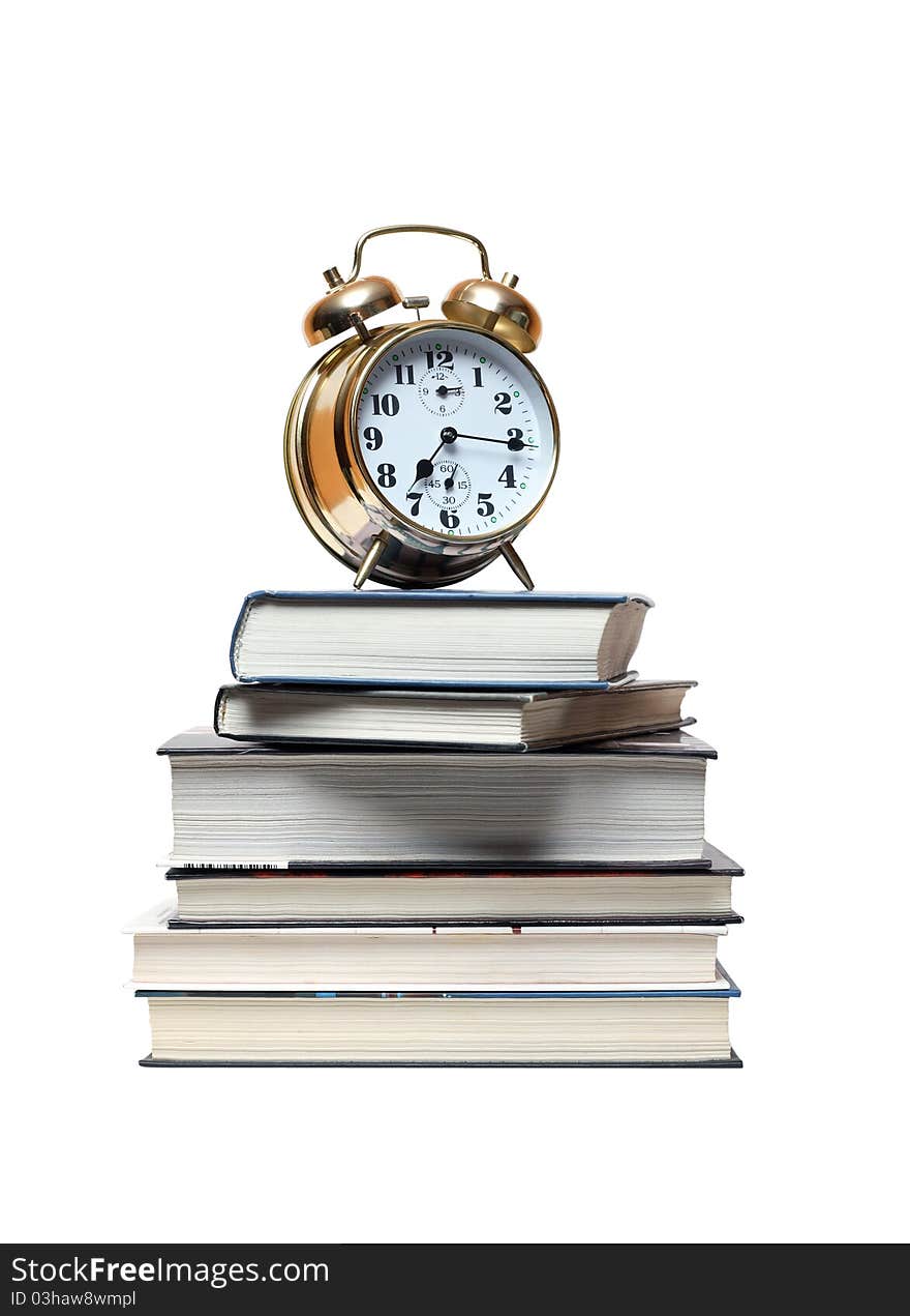 Alarm clock standing on stack of books. Isolated on white with clipping path. Alarm clock standing on stack of books. Isolated on white with clipping path