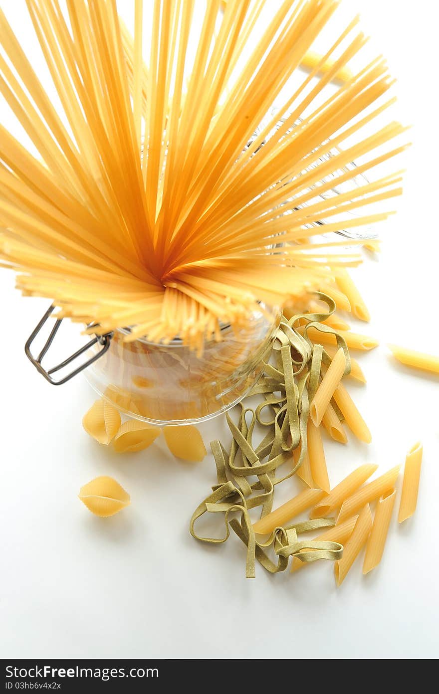 Italian pasta, bunch of spaghetti in a jar, tagliatelle and penne. Italian pasta, bunch of spaghetti in a jar, tagliatelle and penne