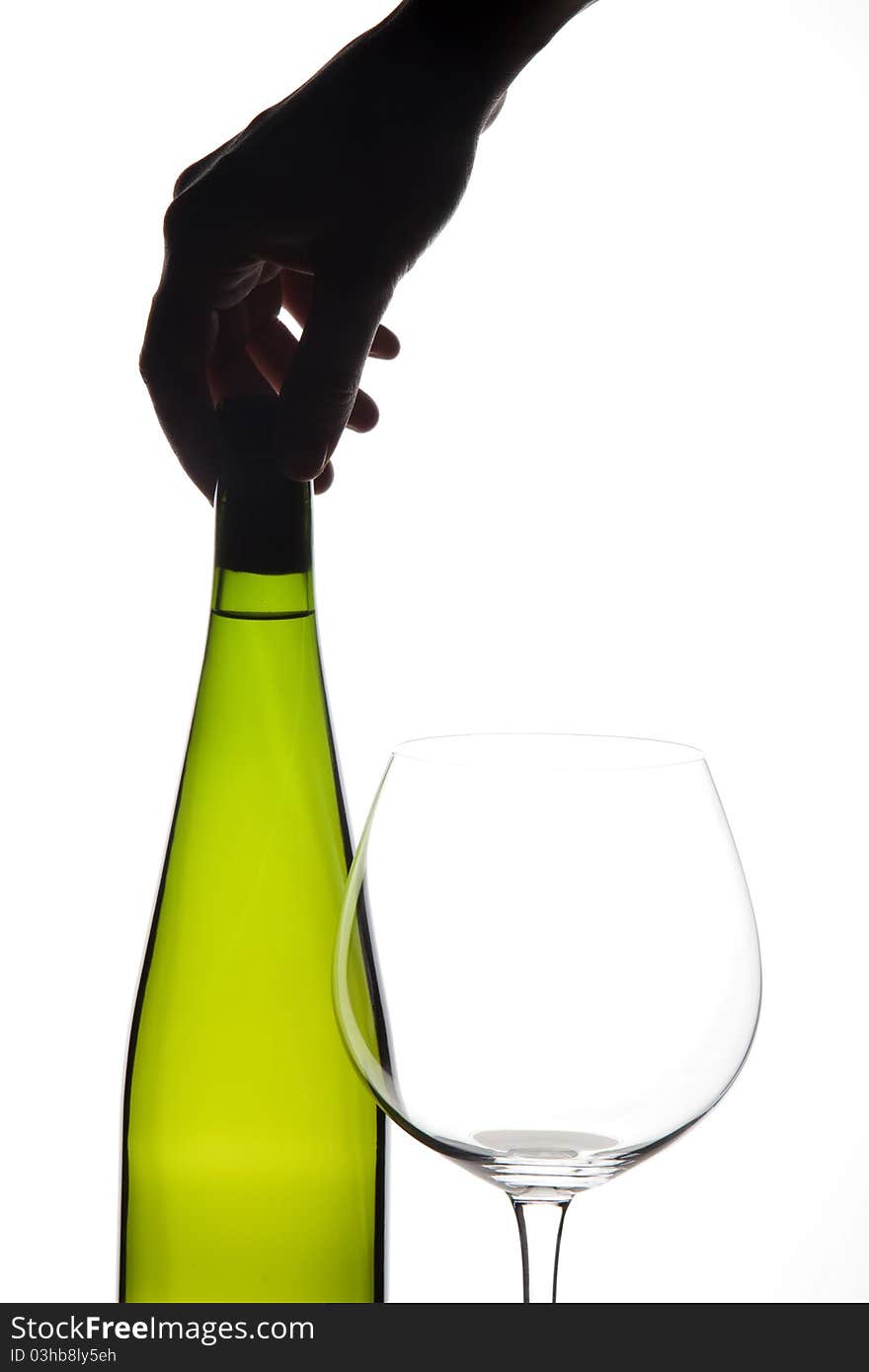 Glass and bottle of white wine with a hand. Glass and bottle of white wine with a hand