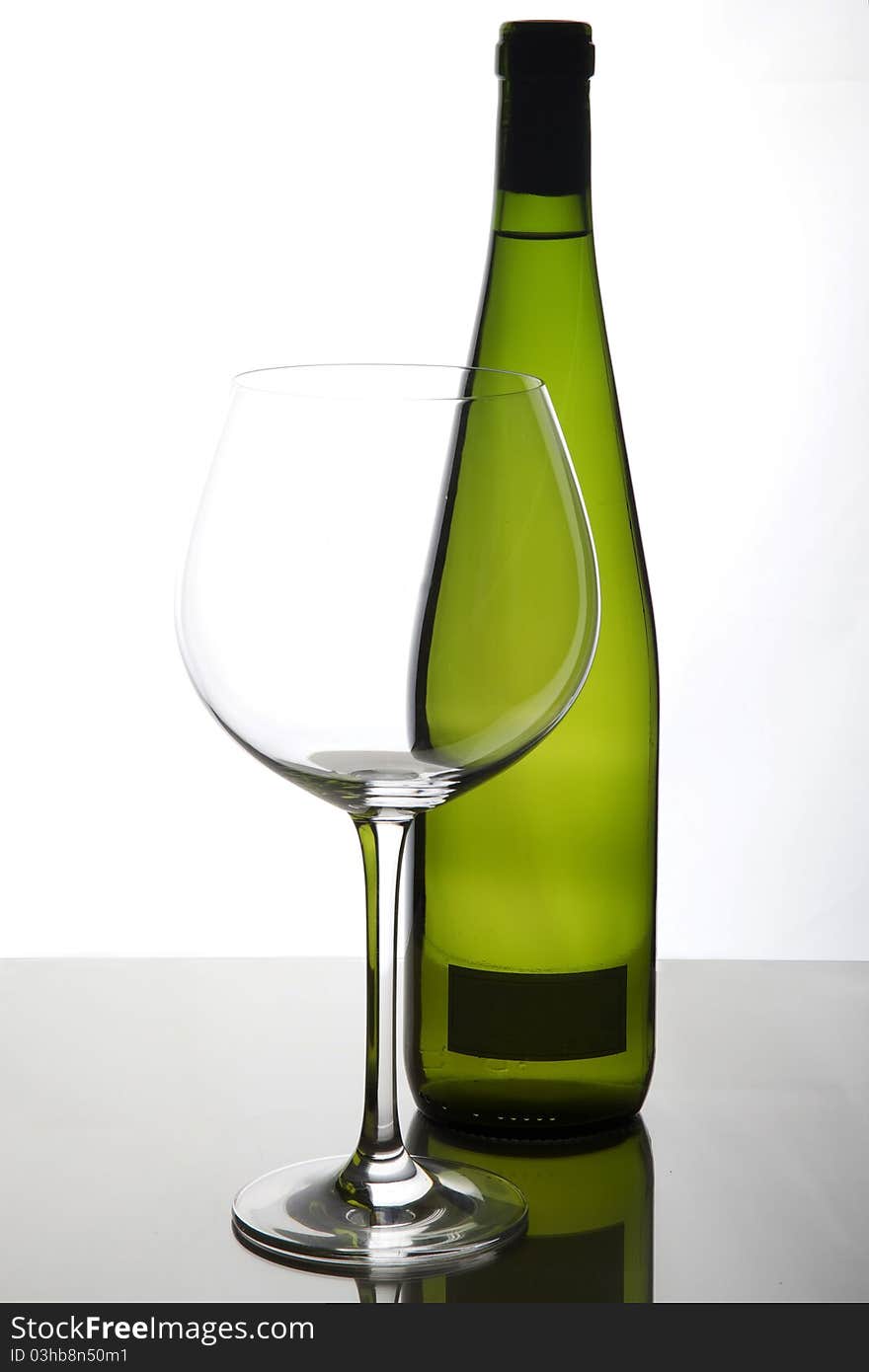 Glass and bottle of white wine. Glass and bottle of white wine