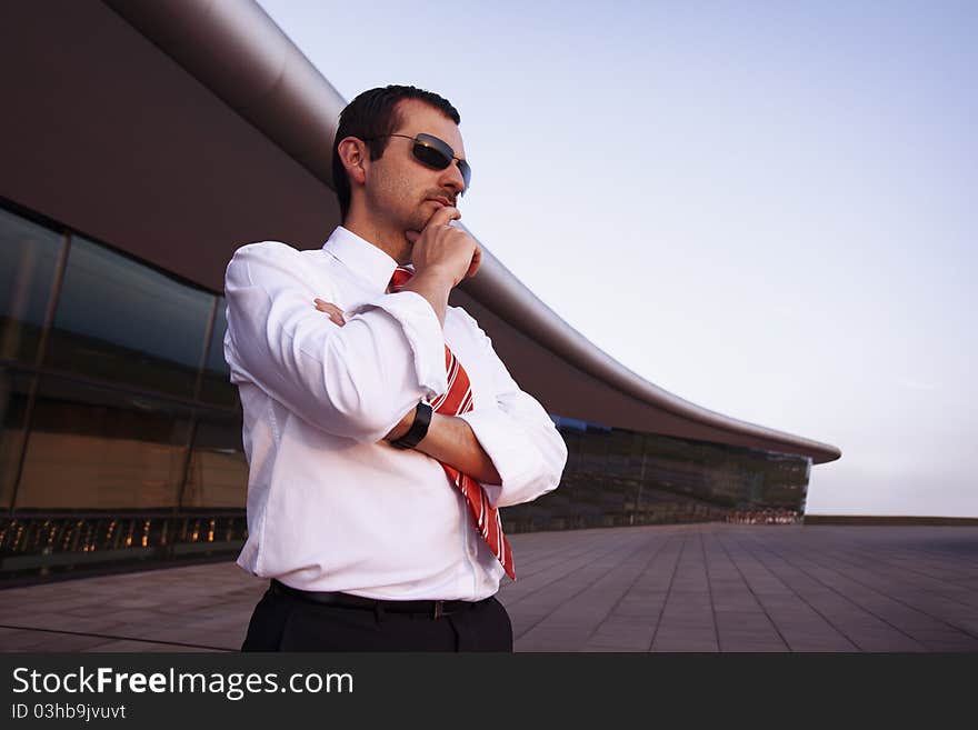 Businessman outdoors contemplating.