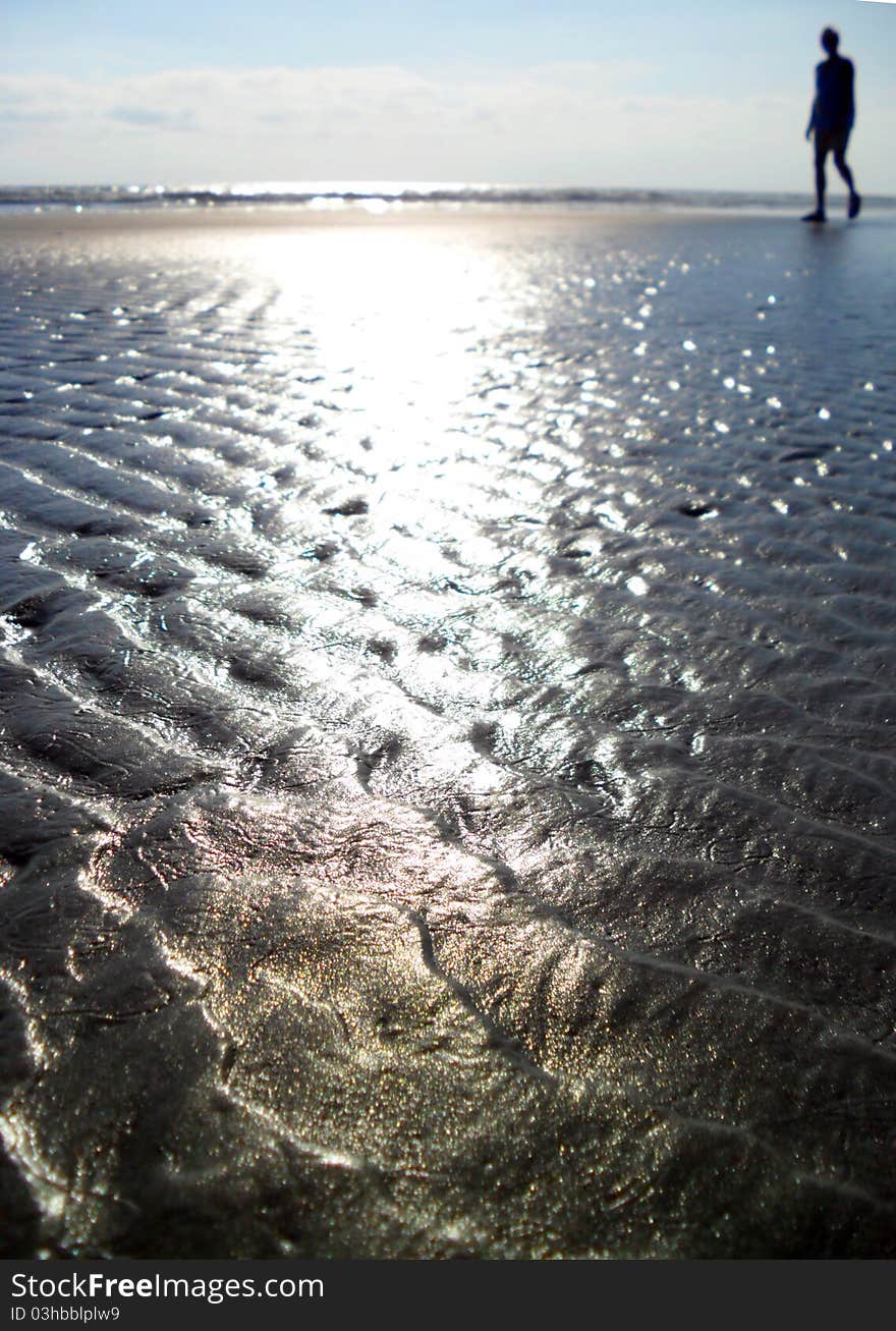 Silhouette of a man walking on the beach. Silhouette of a man walking on the beach