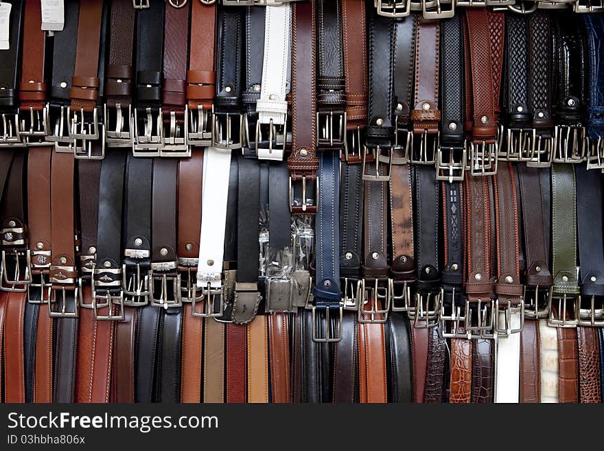 Display of leather belts at an Italian market