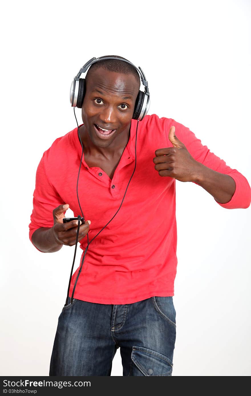 Man with red shirt listening to music with headphones. Man with red shirt listening to music with headphones